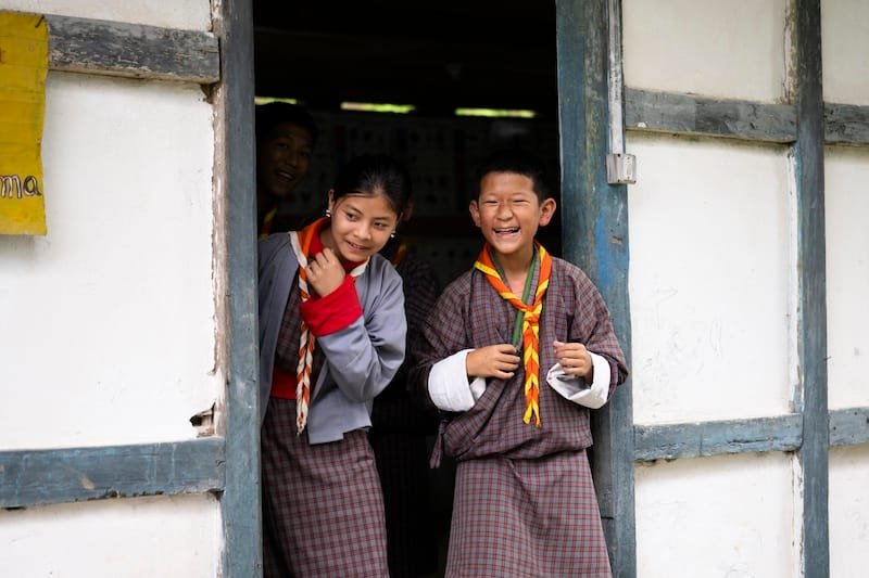 two children in the school gate in Meritsemo, Bhutan